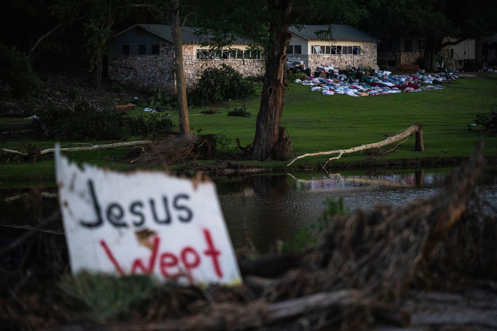 FILE - Camper's belongings sit outside one of Camp Mystic's cabins near the Guadalupe River after a flash flood swept through the area, July 7, 2025, in Hunt, Texas. (AP Photo/Eli Hartman, file)