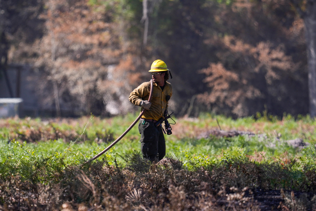 A firefighter works the Brantley Highway 82 fire, Thursday, April 23, 2026, near Nahunta, Ga. (AP Photo/Mike Stewart)