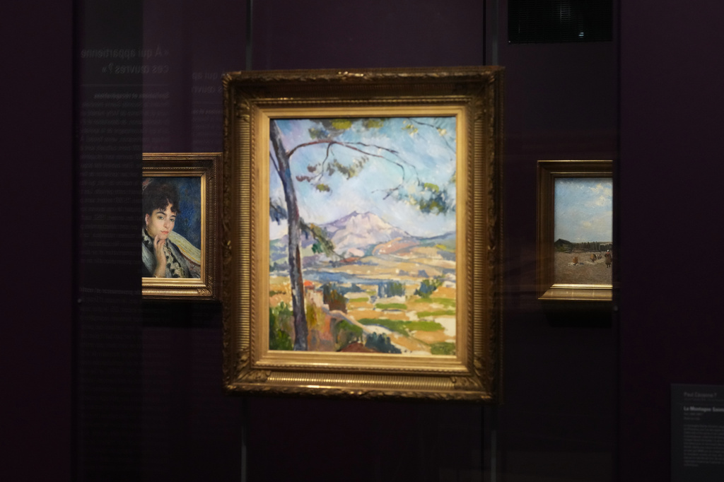 French painter Pierre-Auguste Renoir's painting, "Madame Alphonse Daudet," left, is seen at the Musée d'Orsay museum's new permanent gallery dedicated artworks recovered after World War II whose ownership remains uncertain, in Paris on Monday, May 4, 2026. (AP Photo/Thibault Camus)