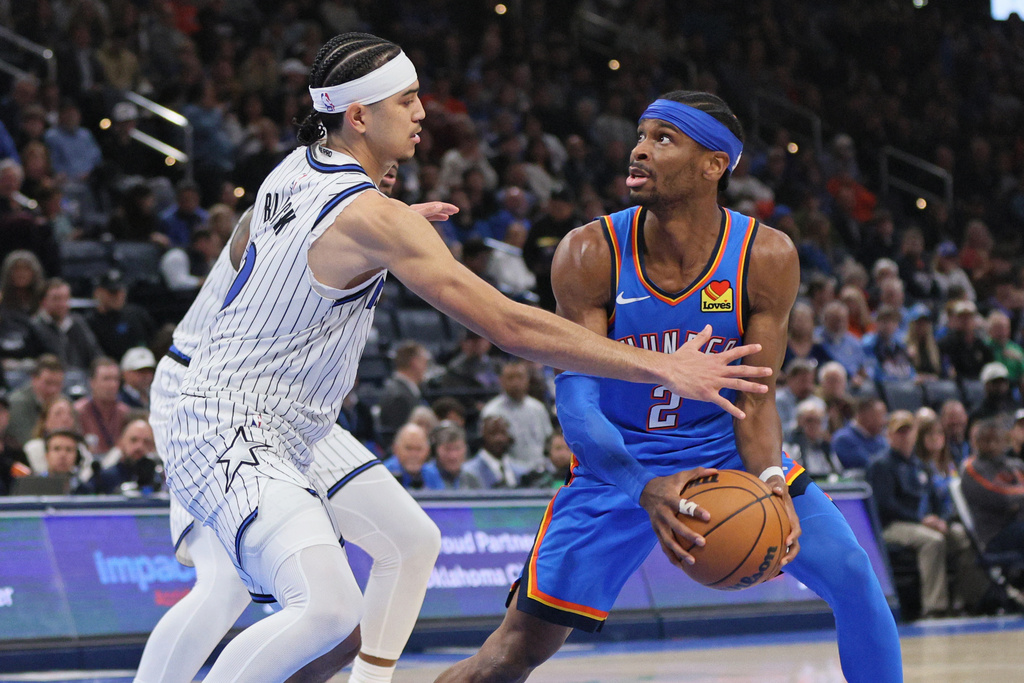 Oklahoma City Thunder guard Shai Gilgeous-Alexander (2) looks for an outlet against Orlando Magic guard Anthony Black, left, during the second half of an NBA basketball game, Tuesday, Feb. 3, 2026, in Oklahoma City. (AP Photo/Nate Billings)
