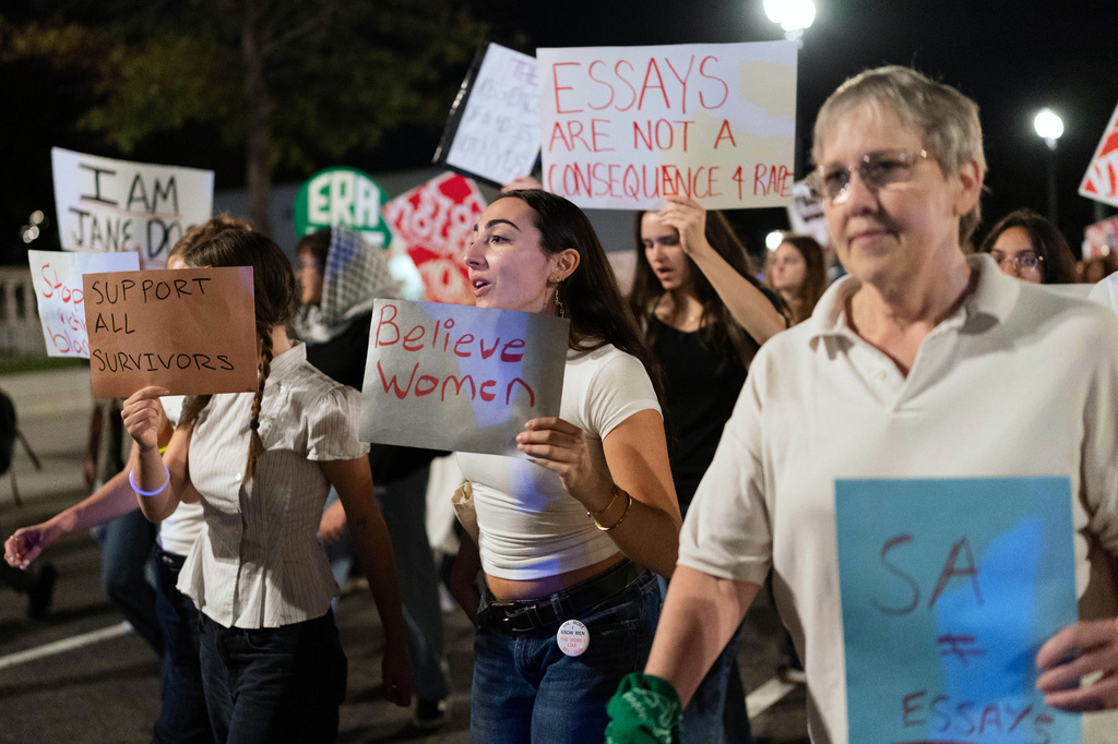Demonstrators march from the Washington Monument to the White House during a "Stop Sexual Violence" protest in Washington, Thursday, Oct. 8, 2026. (AP Photo/Jose Luis Magana)