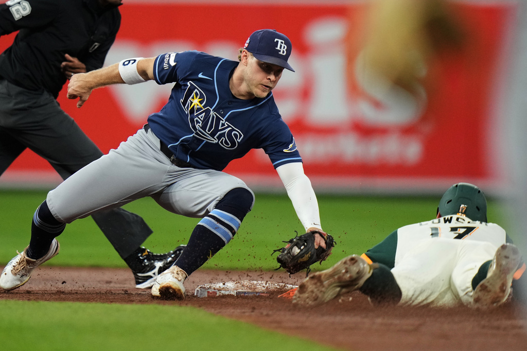 Baltimore Orioles' Colton Cowser, right, is caught stealing second base by Tampa Bay Rays shortstop Taylor Walls, front left, during the second inning of a baseball game, Friday, Aug. 21, 2026, in Baltimore. (AP Photo/Stephanie Scarbrough)
