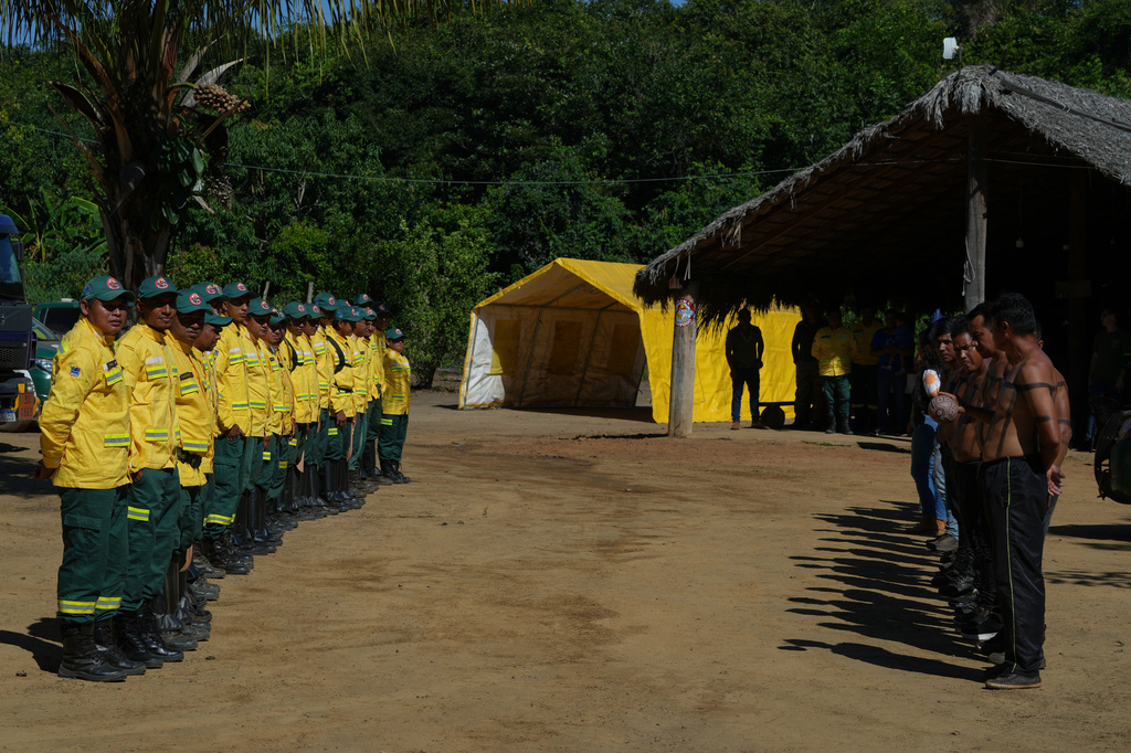 Xerente Indigenous firefighters stand during a fire prevention operation along Brazil's environmental protection agency, IBAMA, at the Xerente territory, near Tocantinia, Tocantins state, Brazil, Tuesday, May 19, 2026. (AP Photo/Andre Penner)