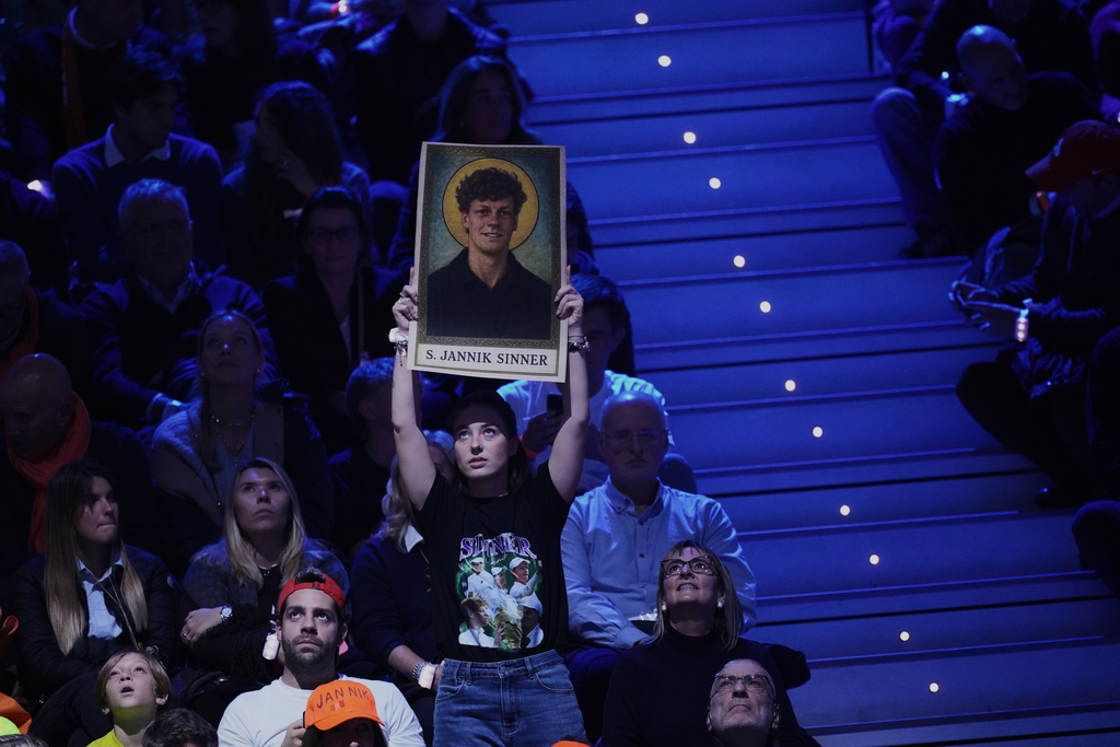 A fan holds a poster. of Italy's Jannik Sinner during his final tennis match of the ATP World Tour Finals against in Turin, Italy, Sunday, Nov. 16, 2025. (AP Photo/Antonio Calanni)