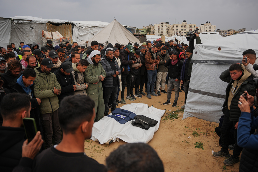 Mourners pray over the bodies of the Palestinian journalists Abd Shaat and Anas Ghoneim who were killed in an Israeli strike on an Egyptian committee's vehicle, during their funeral in Khan Younis, southern Gaza Strip, Thursday, Jan. 22, 2026. (AP Photo/Abdel Kareem Hana)