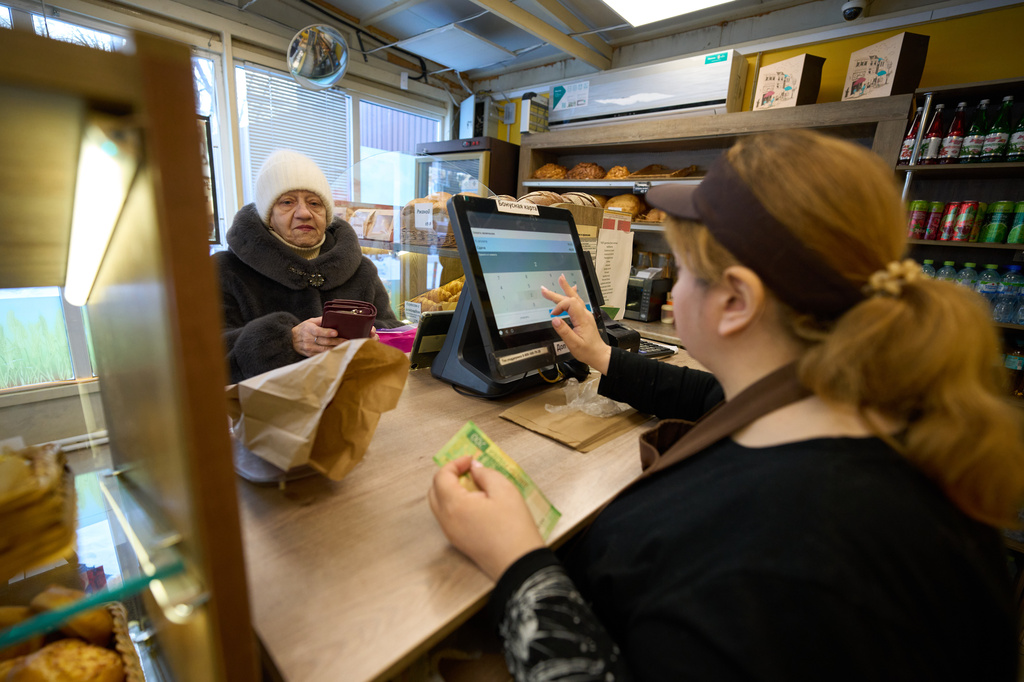 FILE- A customer buys bread at the Mashenka bakery outside Moscow, Russia, on Feb. 18, 2026. (AP Photo/Alexander Zemlianichenko, File)