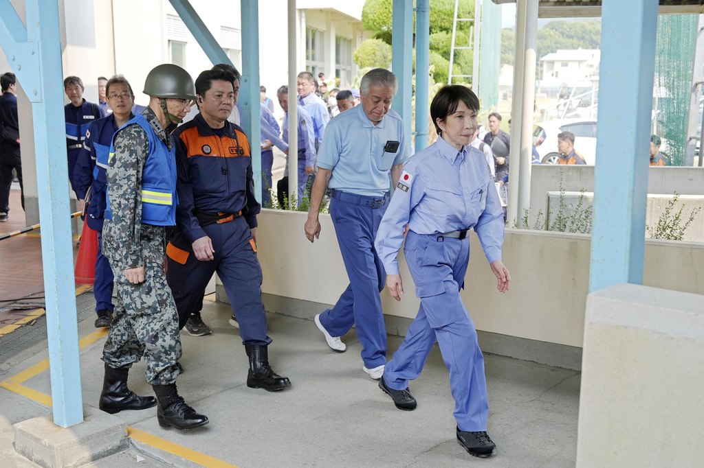 Japan's Prime Minister Sanae Takaichi visits an evacuation center in Hikawa, southern Japan, Monday, Aug. 3, 2026. (Japan Pool/Kyodo News via AP)