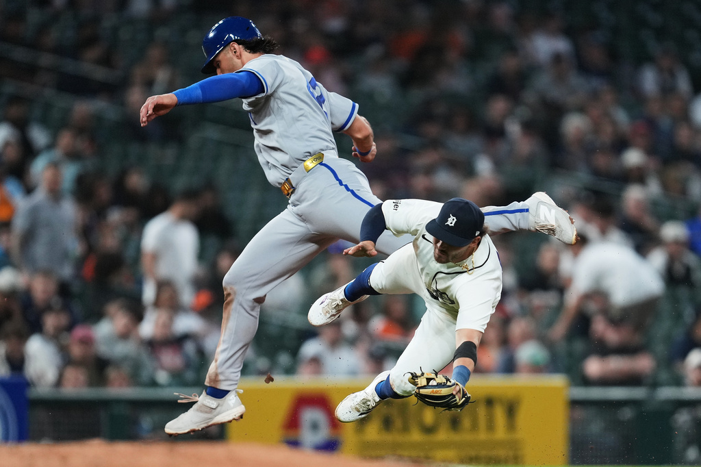 Kansas City Royals' Jac Caglianone, left, runs into Detroit Tigers third baseman Zach McKinstry during the seventh inning of a baseball game Wednesday, April 15, 2026, in Detroit. (AP Photo/Paul Sancya)