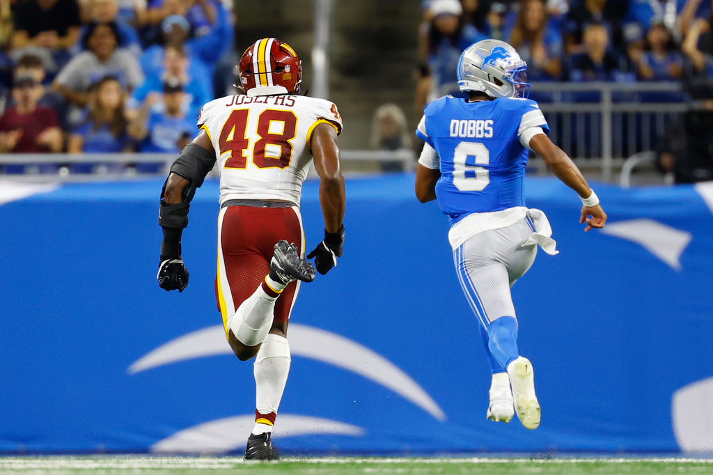 Detroit Lions quarterback Joshua Dobbs (6) runs in for a touchdown against Washington Commanders Joshua Josephs (48) during a preseason NFL football game, Saturday, Aug. 22, 2026, in Detroit. (AP Photo/Rey Del Rio)