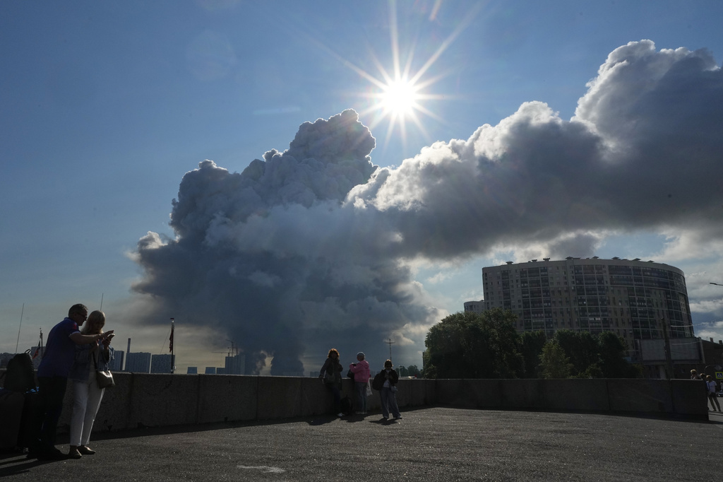 Smoke billows into the sky following Ukrainian drone strikes on warehouses of Russia's online retailer Wildberries, in St. Petersburg, Russia, Friday, July 24, 2026. (UGC via AP)
