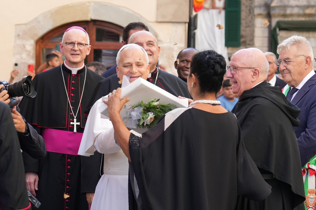 Pope Leo XIV receives a box with butterflies as he arrives at the Basilica Sanctuary of the Mother of Good Counsel in Genazzano, central Italy, Monday, Sept. 7, 2026. (AP Photo/Andrew Medichini)