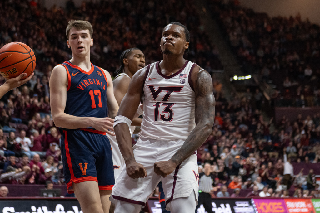 Virginia Tech forward Amani Hansberry (13) celebrates with fans during the first half of an NCAA college football game, Wednesday, Dec. 31, 2025, in Blacksburg, Va. (AP Photo/Robert Simmons)