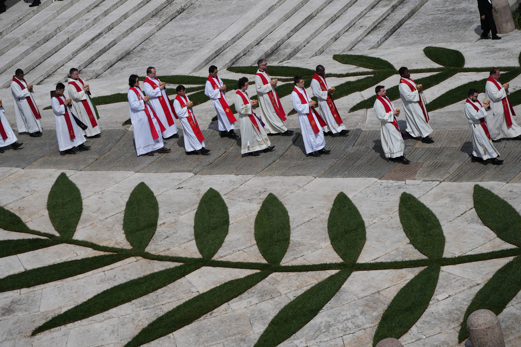 Priests attend Mass presided over by Pope Leo XIV in St. Peter's Square at the Vatican on the Catholic feast of Palm Sunday, commemorating Jesus' arrival in Jerusalem, Sunday, March 29, 2026. (AP Photo/Alessandra Tarantino)