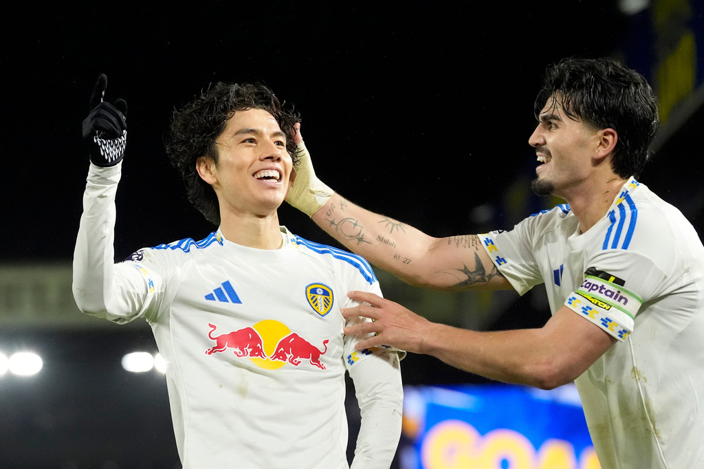 Leeds United's Ao Tanaka celebrates scoring during the English Premier League soccer match between Leeds United and Liverpool in Leeds, England, Saturday Dec. 6, 2025. (Danny Lawson/PA via AP)