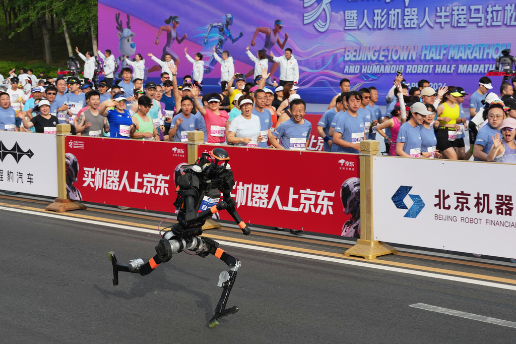 A robot starts off for the Beijing E-Town Half Marathon and Humanoid Half Marathon on the outskirts of Beijing on Sunday, April 19, 2026. (AP Photo/Ng Han Guan)