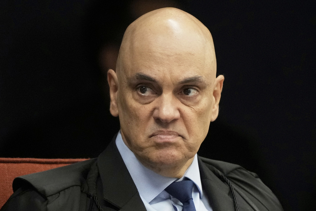 Supreme Court Justice Alexandre de Moraes gestures during the verdict and sentencing phase of a trial for those charged in an alleged coup plot to keep Brazil's former President Jair Bolsonaro in office after his 2022 election defeat, in Brasilia, Brazil, Wednesday, Sept. 3, 2025. (AP Photo/Eraldo Peres)