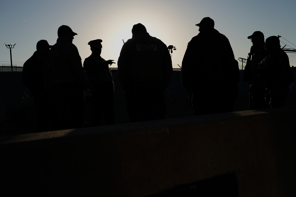Police stand by as protesters gather outside an ICE processing facility in the Chicago suburb of Broadview, Ill., Friday, Nov. 14, 2025. (AP Photo/Nam Y. Huh)