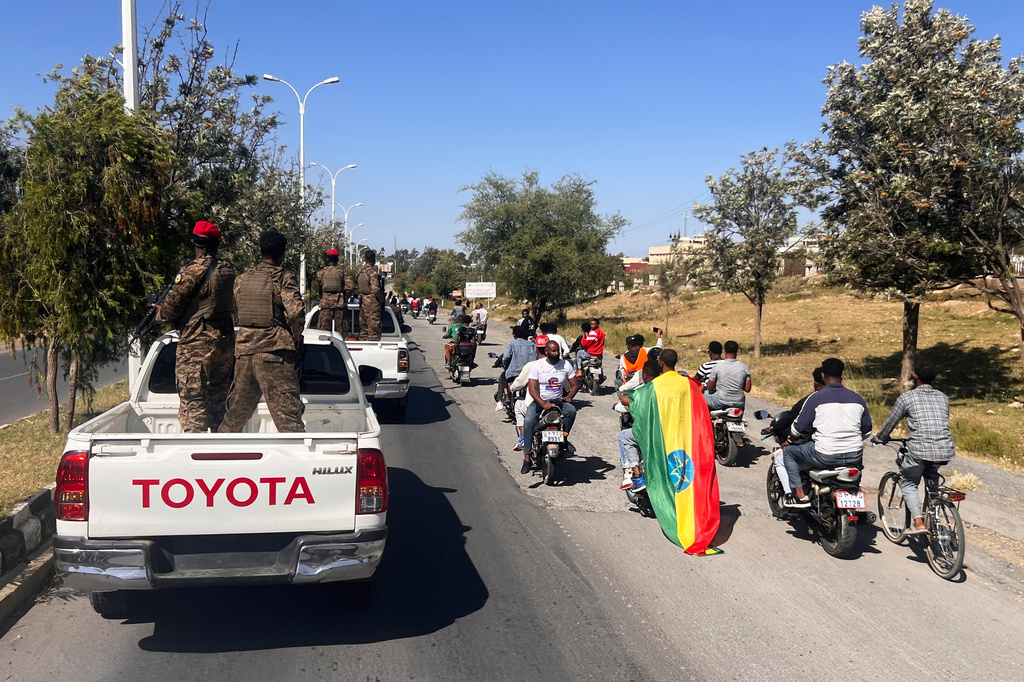 In this photo taken with a smartphone, supporters and soldiers participate in a procession welcoming former Tigray leader Getachew Reda in Mekelle, Ethiopia, Sunday, Oct. 11, 2026. (AP Photo/Filmon Equar Hailu)