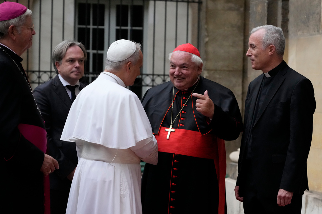 Pope Leo XIV is welcomed by Archbishop of Paris Laurent Ulrich, left, Cardinal Jean-Marc Aveline, second from right, and Institut Catholique de Paris Rector Emmanuel Petit as he arrives to meet with members of the provincial synodal assembly, catechumens and neophytes at the ICP in Paris, Saturday, Sept. 26, 2026. (AP Photo/Gregorio Borgia)