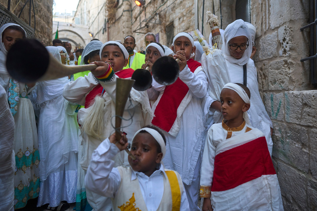 Ethiopian Orthodox Christian worshippers beat drums and sing to celebrate the eve of the Meskel holiday in the streets of Jerusalem's Old City, Saturday, Sept. 26, 2026. (AP Photo/Ohad Zwigenberg)