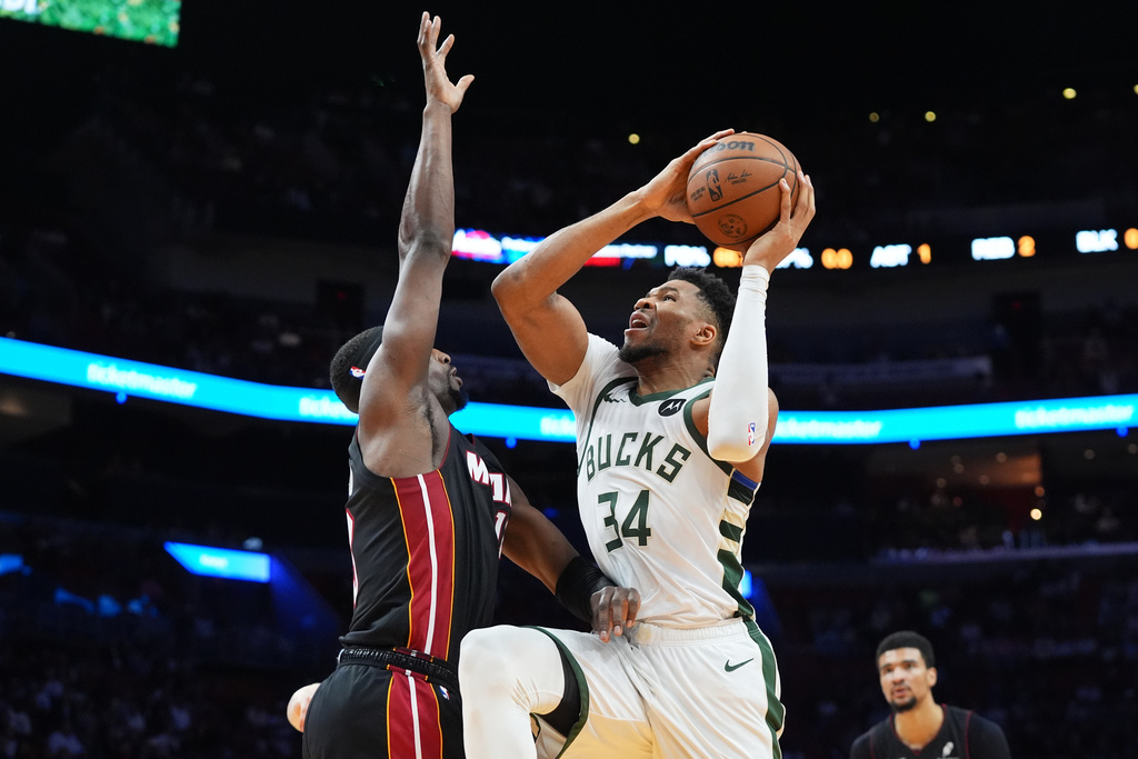 Milwaukee Bucks forward Giannis Antetokounmpo (34) drives to the basket as Miami Heat center Bam Adebayo defends during the first half of an NBA basketball game Thursday, March 12, 2026, in Miami. (AP Photo/Marta Lavandier)