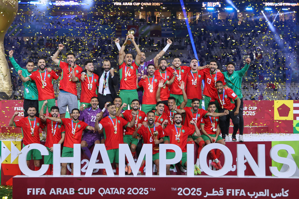 Morocco's players celebrate with the winner trophy after defeating Jordan in the FIFA Arab Cup final soccer match in Lusail, Qatar, Thursday, Dec. 18, 2025. (AP Photo/Hussein Sayed)