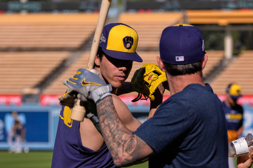 Milwaukee Brewers' Christian Yelich, left, and Brice Turang warm up during practice ahead of Game 3 of baseball's National League Championship Series against the Los Angeles Dodgers, Wednesday, Oct. 15, 2025, in Los Angeles. (AP Photo/Mark J. Terrill) Milwaukee Brewers' Christian Yelich, left, and Brice Turang warm up during practice ahead of Game 3 of baseball's National League Championship Series against the Los Angeles Dodgers, Wednesday, Oct. 15, 2025, in Los Angeles. (AP Photo/Mark J. Terrill)