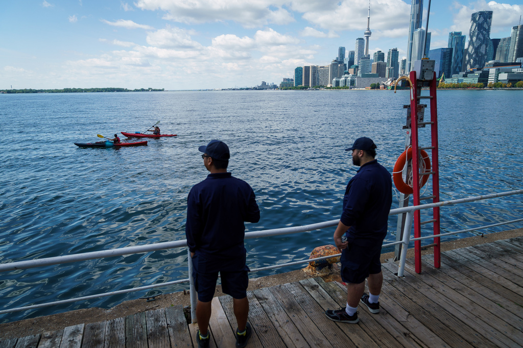 People look out across Lake Ontario from the harbor in Toronto, Tuesday, Aug. 25, 2026. (Keito Newman/The Canadian Press via AP)