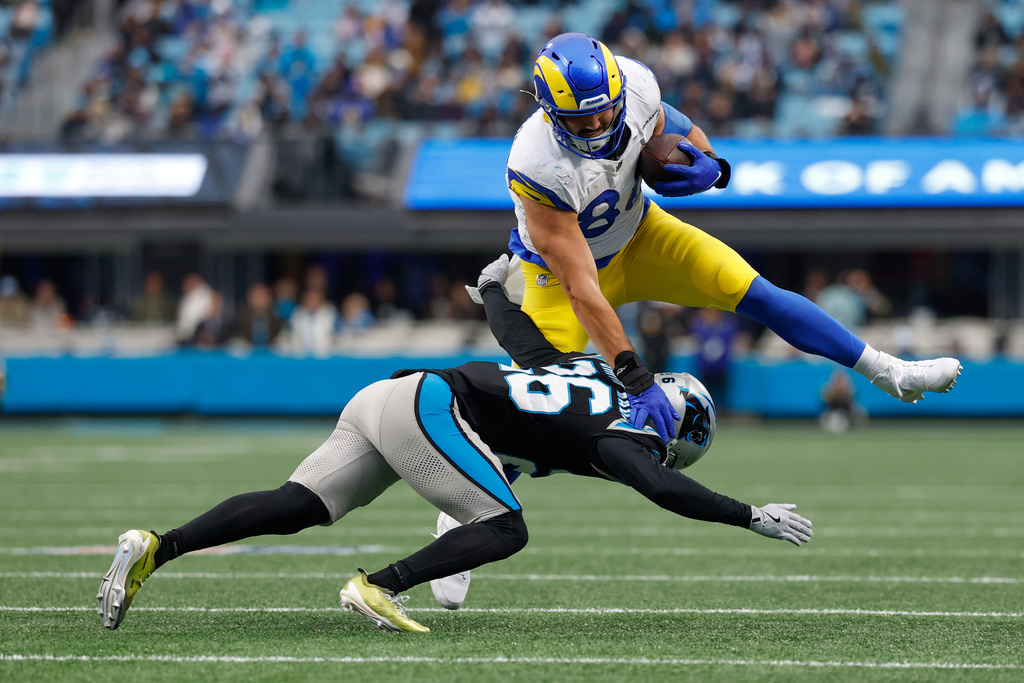 Los Angeles Rams tight end Colby Parkinson goes over Carolina Panthers cornerback Chau Smith-Wadem during the first half of an NFL football game, Sunday, Nov. 30, 2025, in Charlotte, N.C. (AP Photo/Rusty Jones)