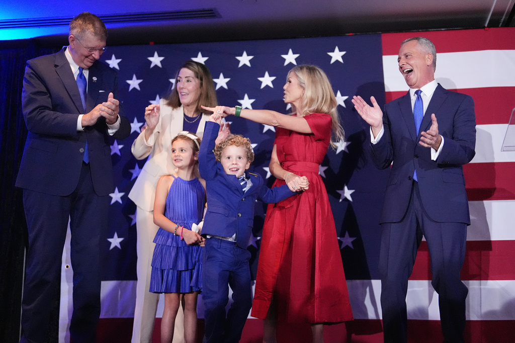 Florida Democratic gubernatorial candidate David Jolly, right, is joined on stage by his family during a primary election night watch party, Tuesday, Aug. 18, 2026, in Miami Lakes, Fla. (AP Photo/Rebecca Blackwell)