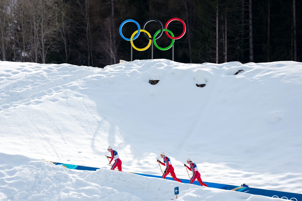 Martin Loewstroem Nyenget, of Norway, from left, Emil Iversen, of Norway, and Johannes Hoesflot Klaebo, of Norway, compete in the cross country skiing men's 50km mass start Classic at the 2026 Winter Olympics, in Tesero, Italy, Saturday, Feb. 21, 2026. (AP Photo/Kirsty Wigglesworth)