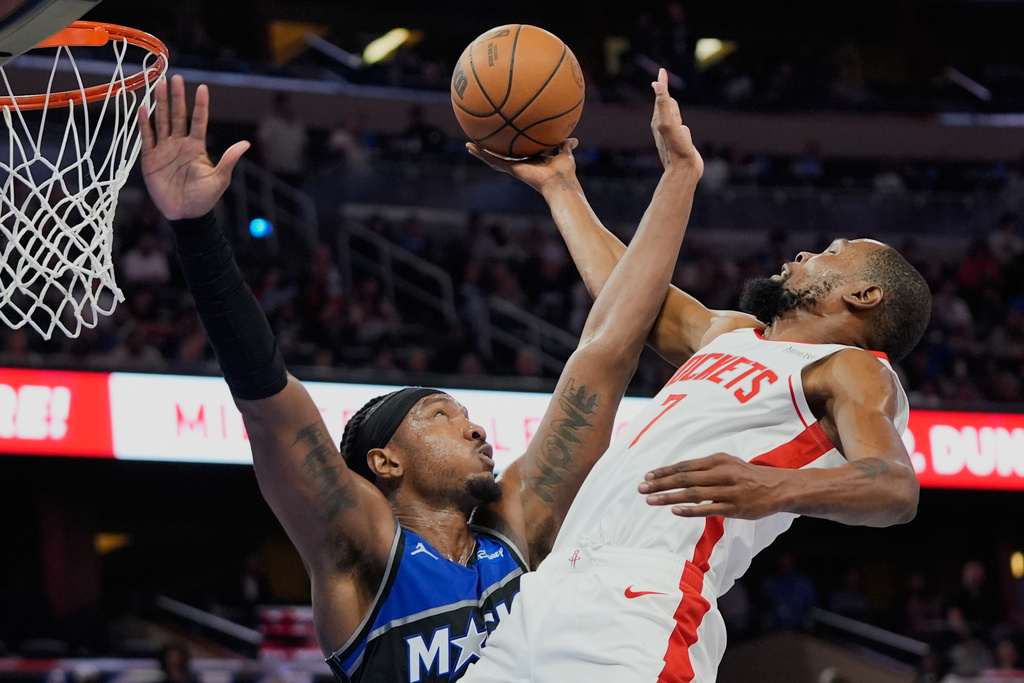 Houston Rockets forward Kevin Durant, right, goes to the basket against Orlando Magic center Wendell Carter Jr. during the second half of an NBA basketball game, Thursday, Feb. 26, 2026, in Orlando, Fla. (AP Photo/John Raoux)