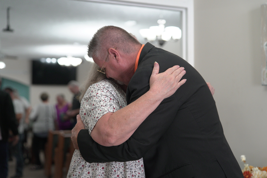 Pastor Jimmy Andrews of Maple Valley Baptist Church comforts a congregant whose grandson works at Accurate Energetic Systems following Sunday service on Oct. 12, 2025, in McEwen, Tenn. (AP Photo/Obed Lamy)