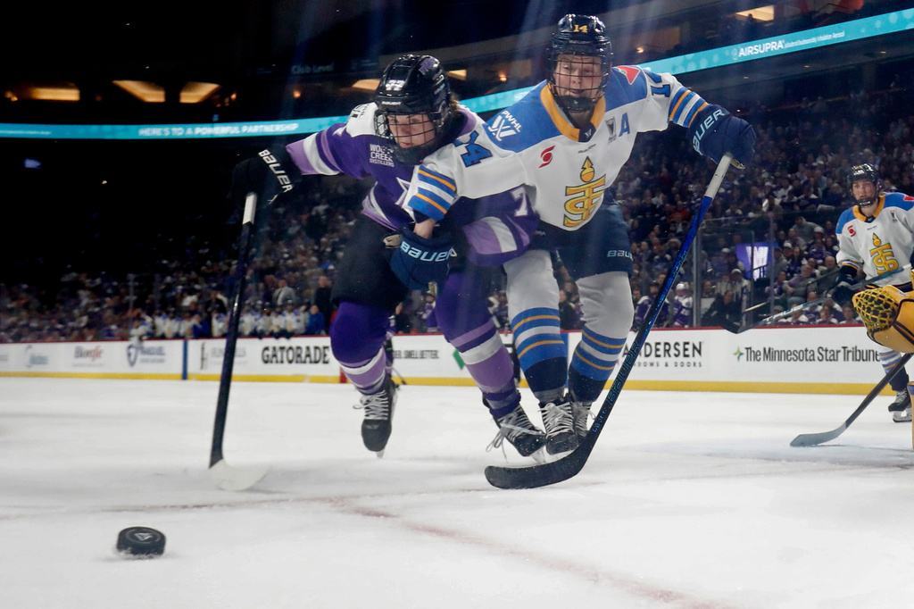 FILE - Minnesota Frost forward Britta Curl-Salemme (77) vies for the puck with Toronto Sceptres forward Natalie Spooner (24) in the second period of a PWHL hockey playoff game May 11, 2025, in St. Paul, Minn. (AP Photo/Bruce Kluckhohn, File)