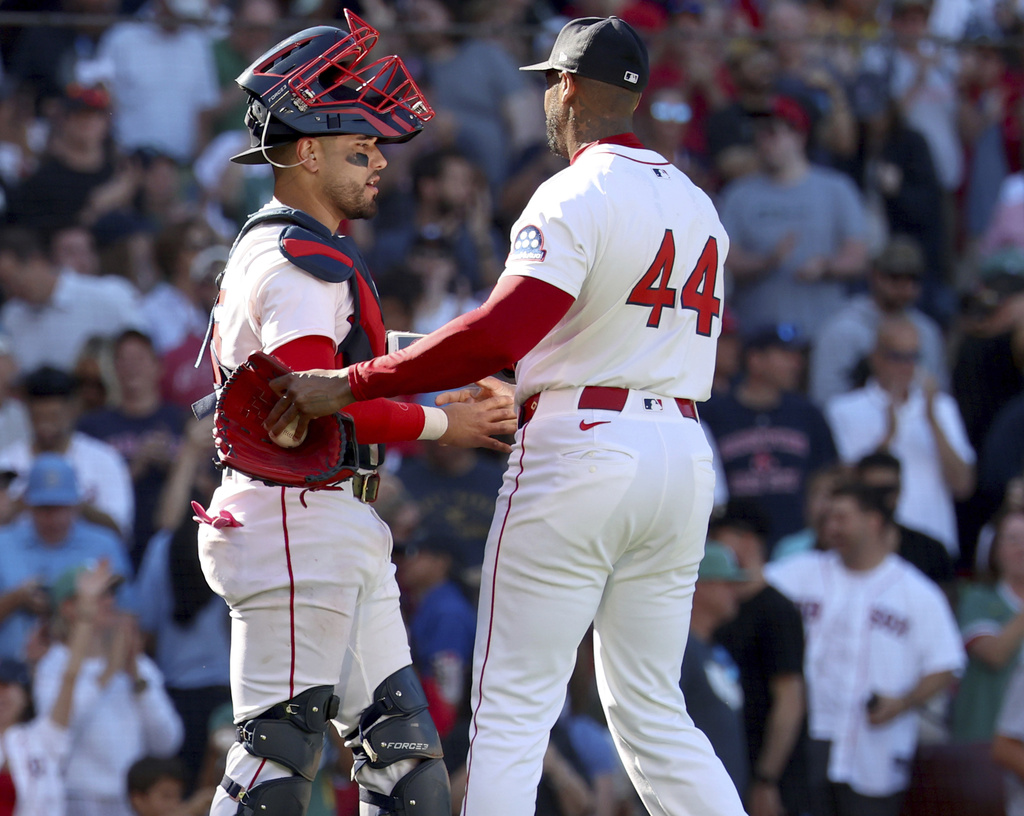 Boston Red Sox catcher Carlos Narváez, left, and Aroldis Chapman (44) shake hands at the end of a baseball game against the Pittsburgh Pirates, Sunday, Aug. 31, 2025, in Boston. (AP Photo/Mark Stockwell)