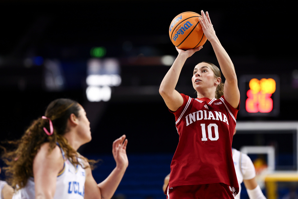 Indiana guard Shay Ciezki (10) looks to shoot against UCLA guard Charlisse Leger-Walker, left, during the first half of an NCAA college basketball game, Sunday, Feb. 15, 2026, in Los Angeles. (AP Photo/Jessie Alcheh)