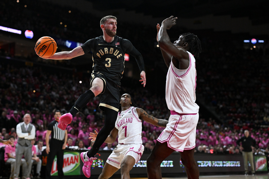Purdue guard Braden Smith (3) looks to pass the ball while being defended by Maryland guard George Turkson Jr., right, during the first half an NCAA college basketball game, Sunday, Feb. 1, 2026, in College Park, Md. (AP Photo/Terrance Williams)