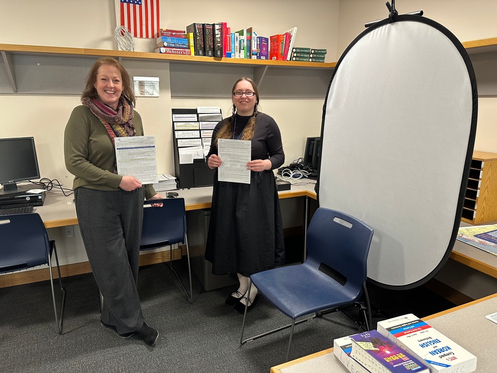 Cathleen Special, executive director of the Otis Library in Norwich, Conn., and Emily Gardiner, the young adult librarian, hold up copies of passport applications on Friday, Feb. 13, 2024, in the room where people used to be able to get their passport processed. (AP Photo/Susan Haigh)