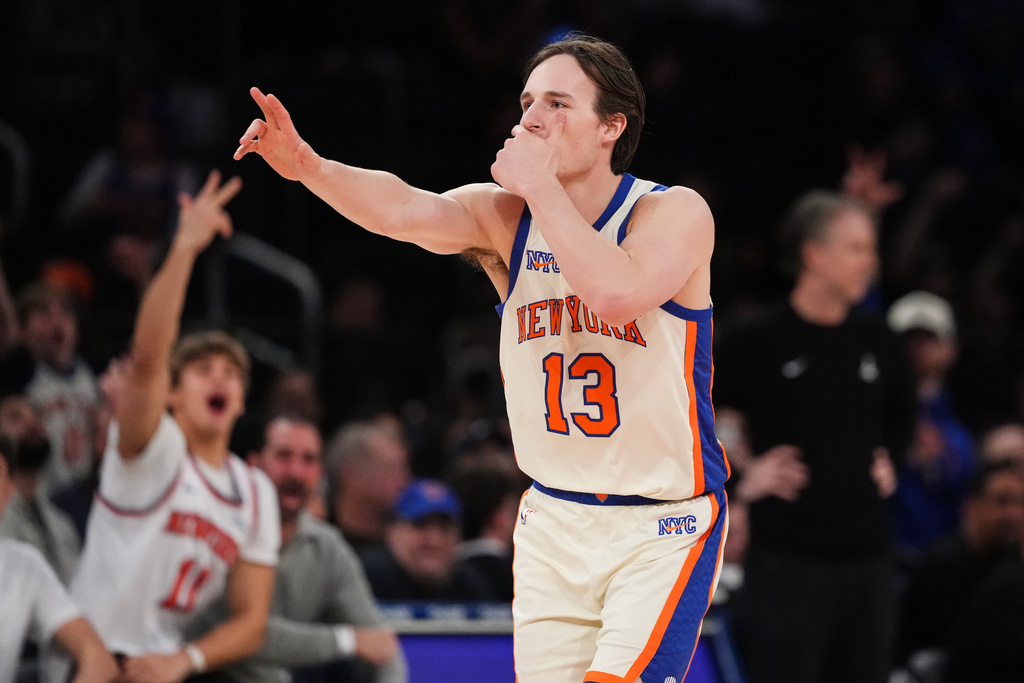 New York Knicks' Tyler Kolek (13) gestures to his team's bench after making a three-point shot during the second half of an NBA basketball game against the Washington Wizards Sunday, March 22, 2026, in New York. (AP Photo/Frank Franklin II)