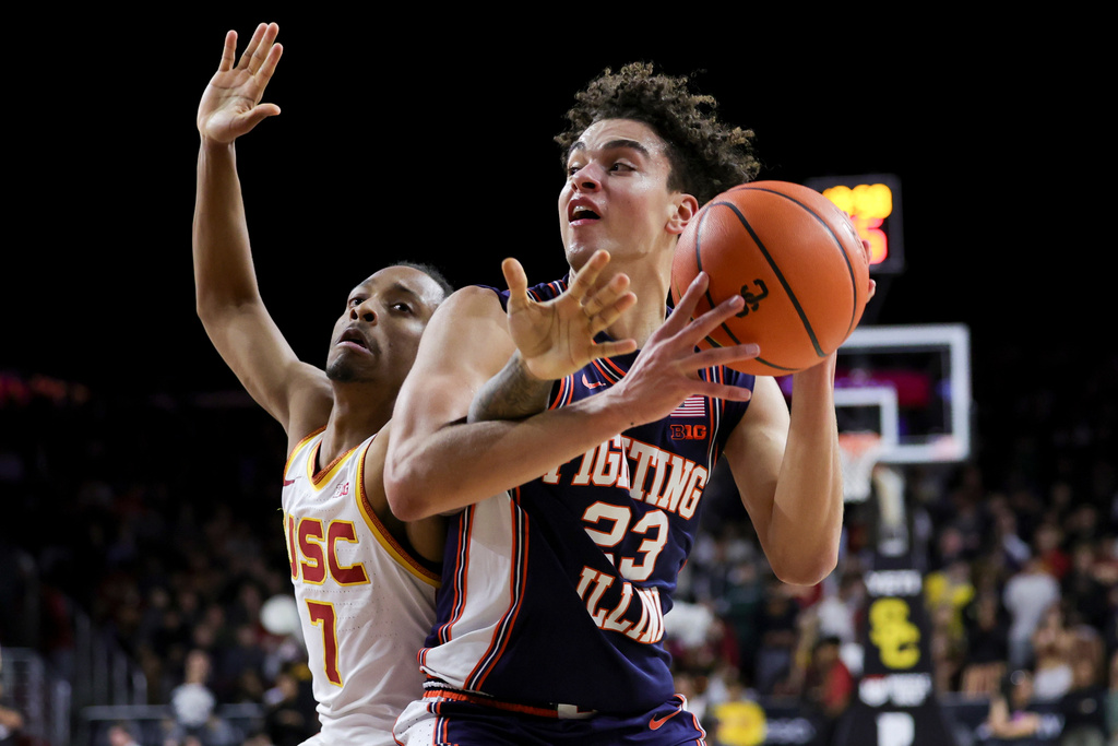 Illinois guard Keaton Wagler, right, drives against Southern California guard Jordan Marsh during the first half of an NCAA college basketball game Wednesday, Feb. 18, 2026, in Los Angeles. (AP Photo/Ryan Sun)