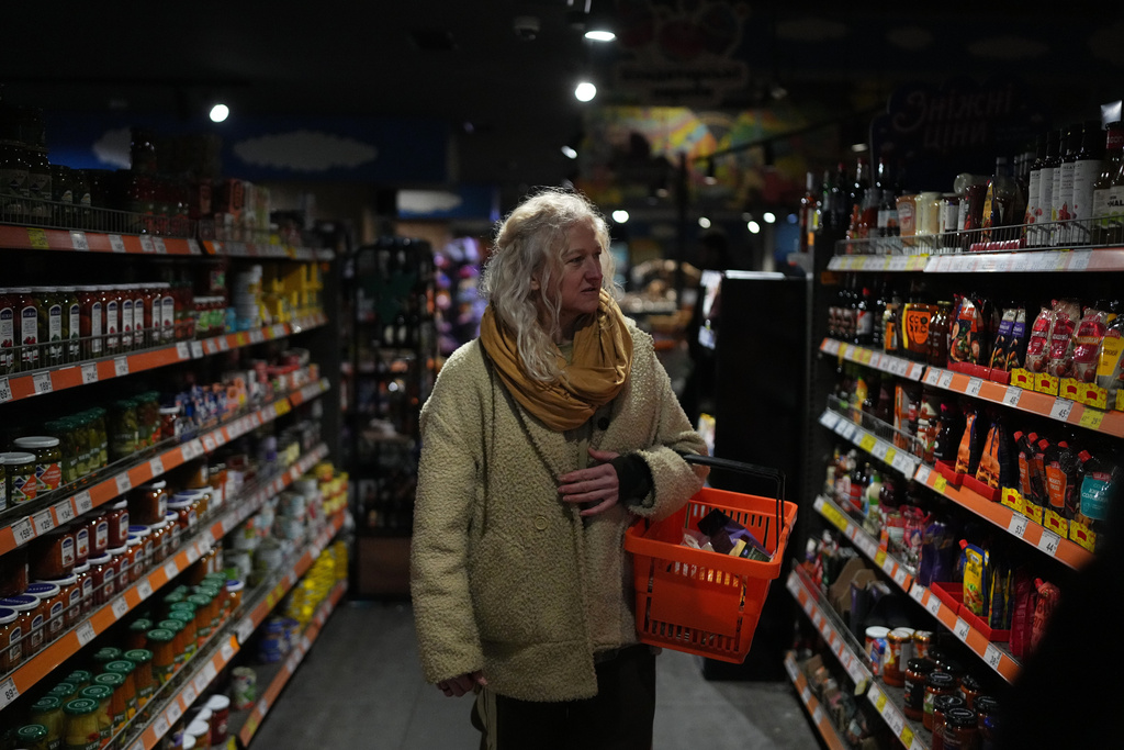 Tetiana Khimion, 47, a dance teacher before Russia's full-scale invasion, now a sniper in the Ukrainian army, shops for groceries in Kyiv, Ukraine, Sunday, Feb. 22, 2026. (AP Photo/Sergei Grits)