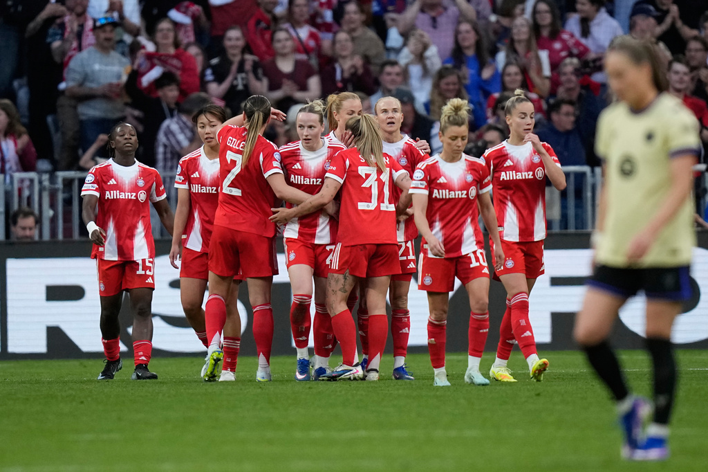Bayern's Franziska Kett, center, celebrates after scoring her side's first goal during the Women's Champions League semifinal first leg soccer match between Bayern Munich and Barcelona in Munich, Germany, Saturday, April 25, 2026. (AP Photo/Matthias Schrader)