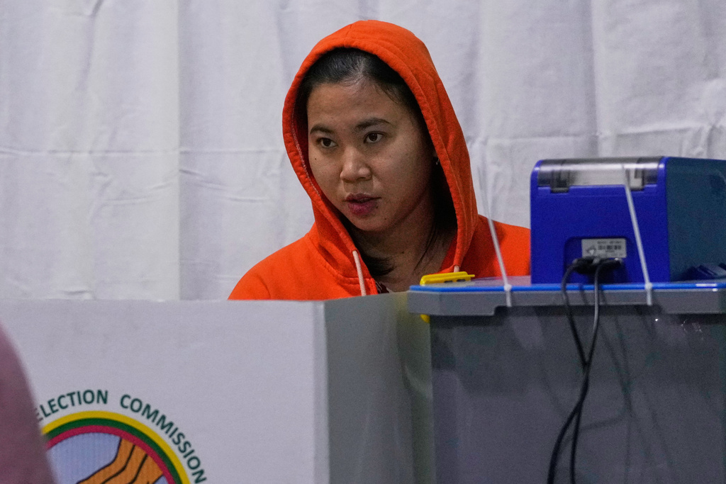 A voter casts ballot at a polling station during the second phase of general election in Mandalay, central Myanmar, Sunday, Jan. 11, 2026. (AP Photo/Aung Shine Oo)