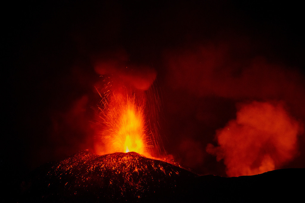 Eruptive activity continues on Mount Etna, where lava flows continue to descend on the slopes of the volcano, as seen from Mareneve near Catania, Italy, Thursday, Aug. 13, 2026. (AP Photo/Salvatore Allegra)