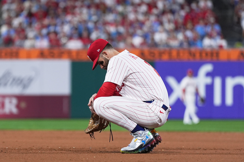 Philadelphia Phillies first baseman Bryce Harper rests during a video review during the eighth inning in Game 2 of baseball's National League Division Series against the Los Angeles Dodgers, Monday, Oct. 6, 2025, in Philadelphia. (AP Photo/Matt Slocum)