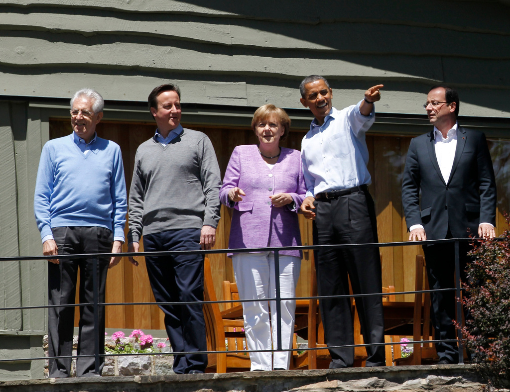 FILE - From left, Italian Prime Minister Mario Monti, British Prime Minister David Cameron and German Chancellor Angela Merkel and French President Francois Hollande, right, listen as President Barack Obama shows off the grounds at the G-8 Summit Saturday, May 19, 2012 at Camp David, Md. (AP Photo/Charles Dharapak, File)