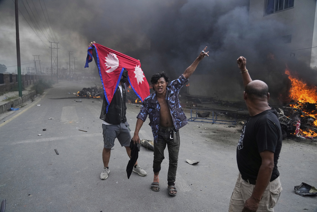 Protesters vandalize Nepalese congress party central office during protests against social media ban and corruption in Kathmandu, Nepal, Tuesday, Sept. 9, 2025. (AP Photo/Niranjan Shrestha)