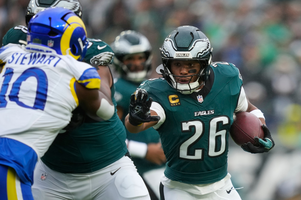 Philadelphia Eagles running back Saquon Barkley (26) runs with the ball during the first half of an NFL football game against the Los Angeles Rams in Philadelphia, Sunday, Oct. 4, 2026. (AP Photo/Matt Slocum)