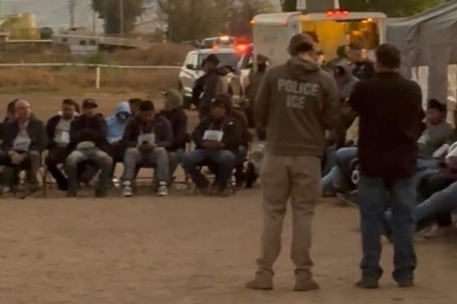 This image from video provided by Nikki Ramirez-Smith shows people being processed by law enforcement agents during a raid at La Catedral Arena horse race track in Wilder, Idaho, on Oct. 19, 2025. (Nikki Ramirez-Smith via AP) This image from video provided by Nikki Ramirez-Smith shows people being processed by law enforcement agents during a raid at La Catedral Arena horse race track in Wilder, Idaho, on Oct. 19, 2025. (Nikki Ramirez-Smith via AP)