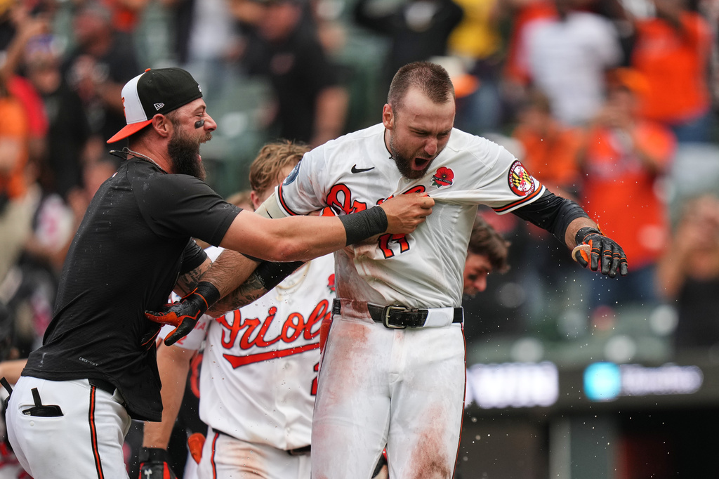 Baltimore Orioles' Colton Cowser, right, celebrates with teammates after hitting a walkoff two-run home run during the 13th inning of a baseball game against the Tampa Bay Rays, Monday, May 25, 2026, in Baltimore. (AP Photo/Stephanie Scarbrough)
